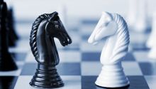 Chess pieces; God vs. Satan.