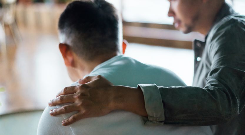 Photo of a man with his hand on the shoulder of another man to illustrate the article How to Confess Your Sins to One Another
